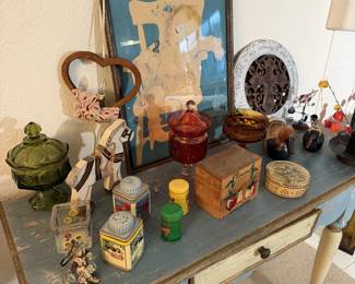 Green glass compote, vintage tins, little wooden boxes and folk art. Pure shelf candy.