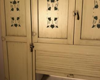 Hand stenciled flower doors up close. Charm you just can't fake.