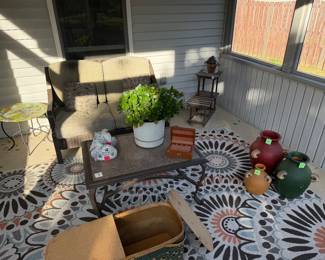 Patio loveseat, coffee table, bird bath and outdoor decor