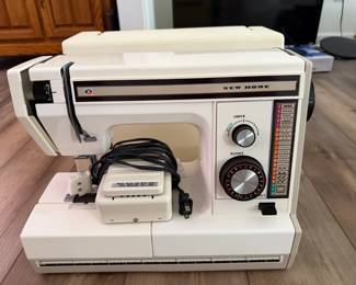 Lot 7312802: Vintage New Home Heavy-Duty Sewing Machine with Multiple Stitch Patterns, Foot Pedal & Case