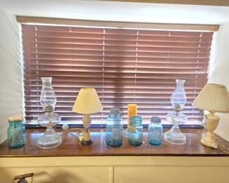 Collection Of Vintage Blue Ball Mason Jars, Clear Glass Oil Lamps, And Decorative Table Lamps