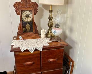 Vintage wooden four-drawer storage chest • Antique Mantel Clock • Brass Table Lamp • Vintage Oil Lamp
