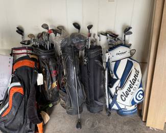 Lots of Golf Clubs and Bags
