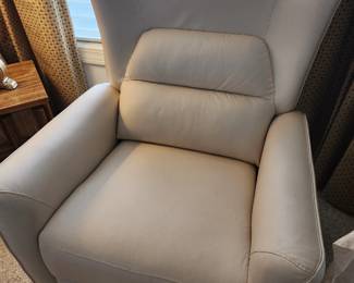 Cream-White Power Swivel Rocker Recliner with a Wingback Design.