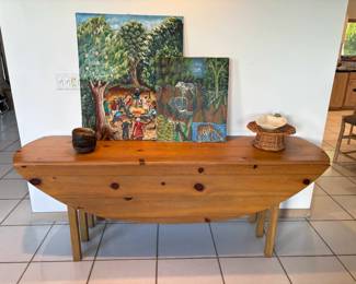 This pine drop leaf table is about 6' feet long and opens into an oval shape. When not in use, tuck it behind the sofa as a console table :)