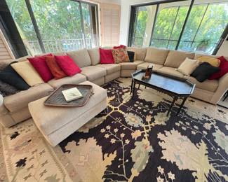 The rug is black and off white with a smattering of soothing greens, blues & pinks.