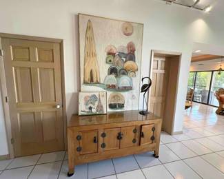 Long & low asian console with ornate hardware & lock. On top of the console are two pieces by Shay Rieger, an internationally known artist.