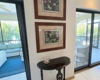 Love that little black lacquer half moon table topped by two Dan Goad numbered lithographs.