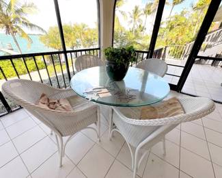 Wicker dining set. Great condition, thick glass top.