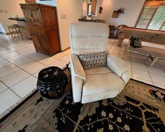 Oh, lawdy! This upholstered recliner lifts AND massages. Love that little black lacquer stool/side table too.