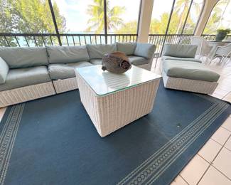White wicker with upholstered cushions in light gray/blue.