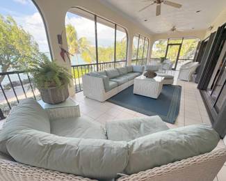 Never seen anything quite like this 10 piece patio sectional. It's white wicker, low to the ground, with upholstered (and washable) cushions and covers in a light blue/gray. It comes with two glass topped tables. It's a steal for the whole set, but would consider separating too.
