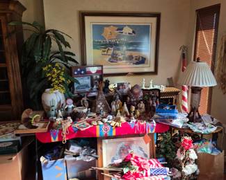 Table of Native American-style figures with framed beach print and lamp