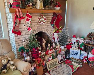 Brick fireplace with Christmas stockings, trees and plush decor