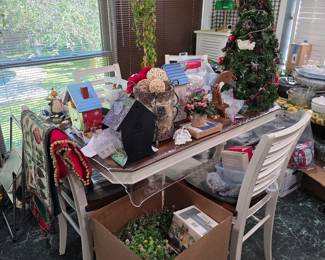 Kitchen table with Christmas decor, white chairs and boxes