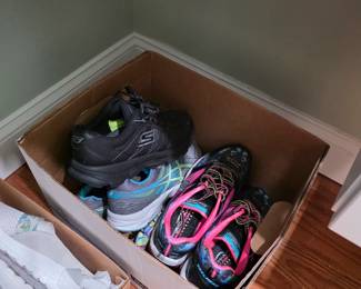 Box of women's athletic sneakers