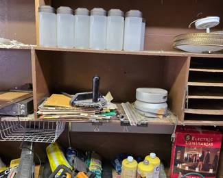 Garage shelves with power tools, jugs and electrical supplies
