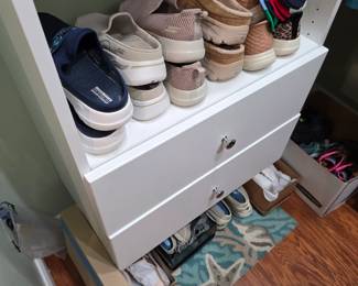 Women's sneakers and casual shoes on closet shelf