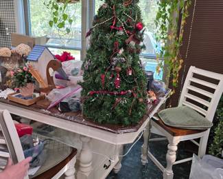 Kitchen dining table with Christmas tree and white chairs