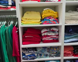 Women's folded shirts in yellow, red and navy with hanging tops