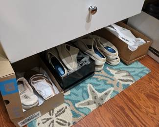 Women's sandals and slides in boxes on starfish rug