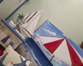 Painted sailboat canvas with nautical chest and sailboat model