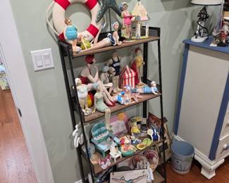 Black metal shelf with nautical life ring, starfish and beach figures