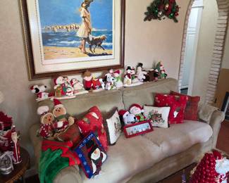 Living room sofa with Christmas pillows and framed beach print