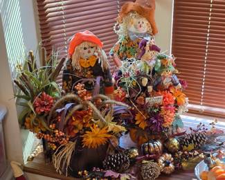 Fall harvest decor with scarecrows, sunflowers and pinecones