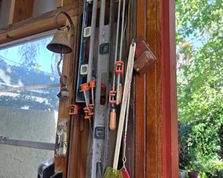 Levels, clamps and hand tools hung on garage wall