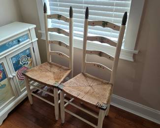 Pair of white ladder-back chairs with rush seats
