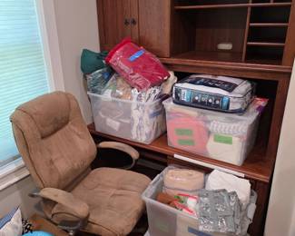 Wood hutch desk with tan office chair and storage bins