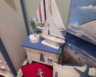 Nautical sailboat models and anchor pillows with painted beach canvas