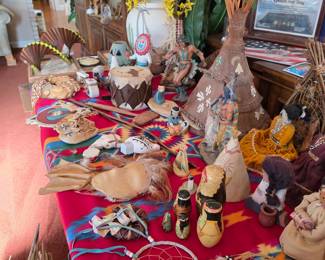 Native American-style dolls, teepee and dreamcatchers on red table
