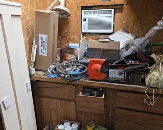 Workbench with wall clock, power cords and window AC unit