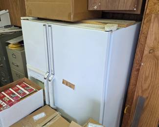 White refrigerator with stacked puzzle boxes