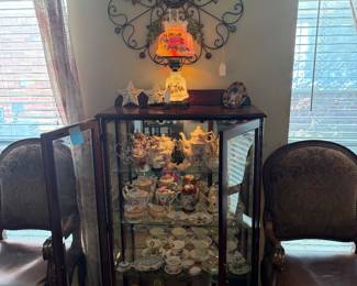 Lighted curio cabinet with vintage tea cups & teapots