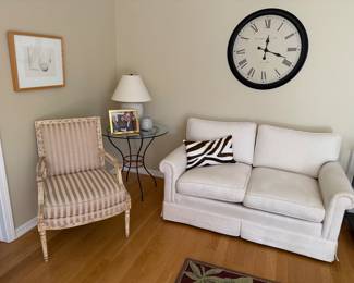 Striped chair, cream loveseat, Pottery barn lamp, wrought iron table