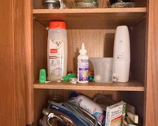 Assorted Household and Pet Care Items in Cabinet