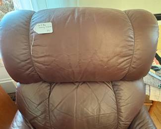 R31 - $100. Brown leather La-Z-Boy rocking recliner. Very good condition. No holes or rips noted. Measures 33" x 36" x 39" tall. 