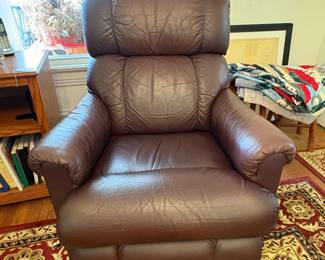 R31 - $100. Brown leather La-Z-Boy rocking recliner. Very good condition. No holes or rips noted. Measures 33" x 36" x 39" tall. 