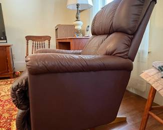 R31 - $100. Brown leather La-Z-Boy rocking recliner. Very good condition. No holes or rips noted. Measures 33" x 36" x 39" tall. 