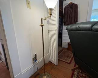 R29 - $50. Brass floor lamp with swinging arm good vintage condition. Works great. 54" tall.