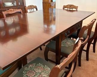 R24 - $250. Georgetown galleries mahogany dropleaf table with eight chair chairs. Fully opened it measures 42" x 74" x 30" tall. With the leaves down it is only 26.5" wide. Very good vintage condition. Has a storage drawer on either side that slide easily.