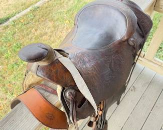 Lot 314 Dark Brown Roping Saddle with Breast Collar, Cinch, Latigo, Rear Cinch, and StirrupsFloral Tooled