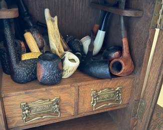 antique oak pipe case with collection of pipes