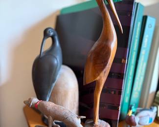 various carved wood bird and dog figures