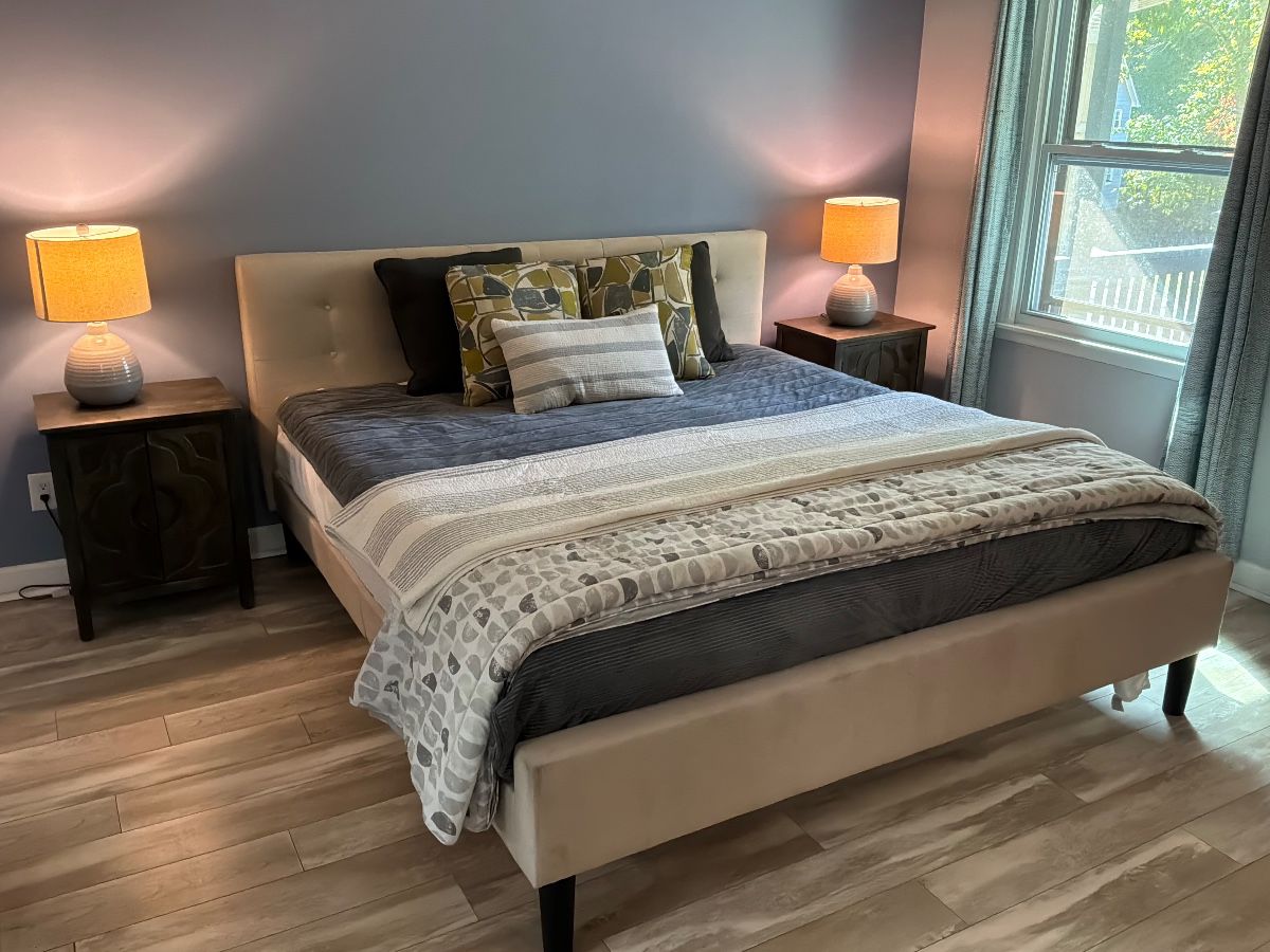 Upholstered king plattform bed frame with matching nightstands and pair of matching lamps 