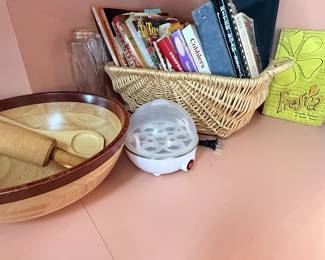 Assortment of cook books. Egg maker. Wooden salad bowl