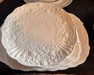 Vintage ivory ceramic serving bowl with embossed floral and scalloped design. Features visible crazing consistent with age. Brand unknown.